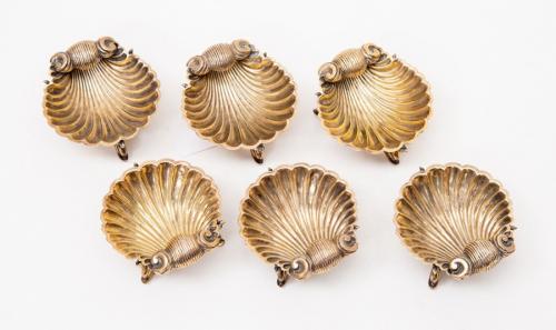 A set of six silver gilt scallop shell shaped salts, each standing on three stylised dolphin feet, hallmark London 1877, Henry Holland, weight approx 246gms