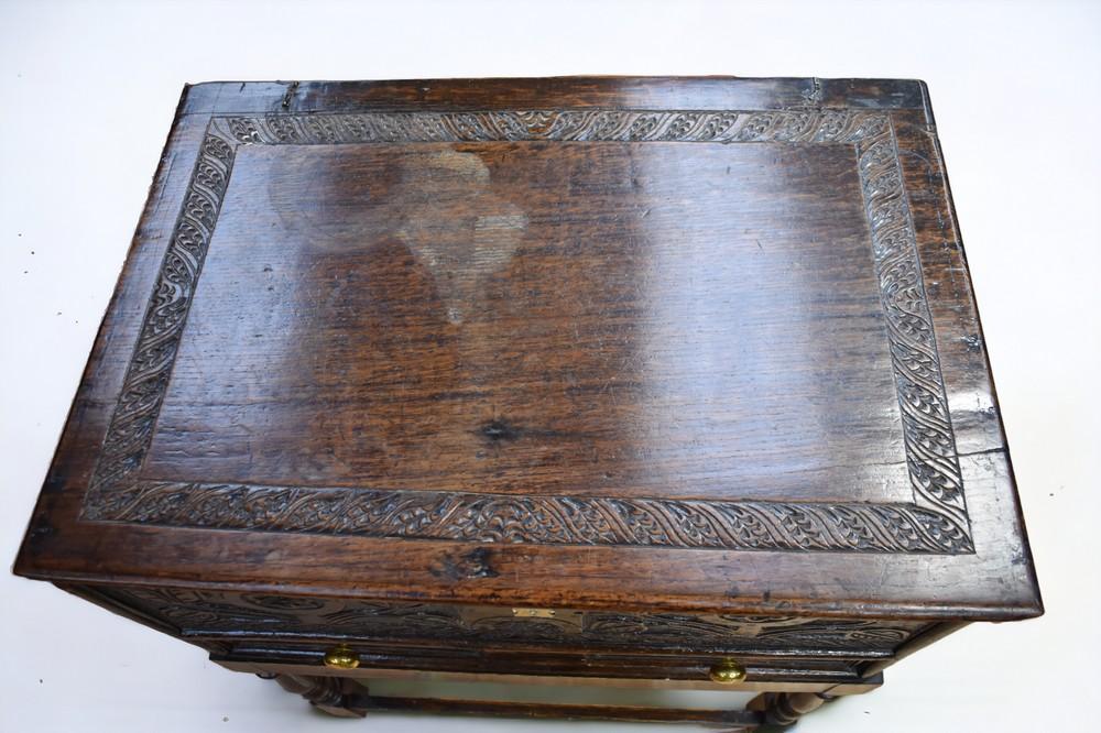 An early 18th century English oak carved Bible box on a stand with ...