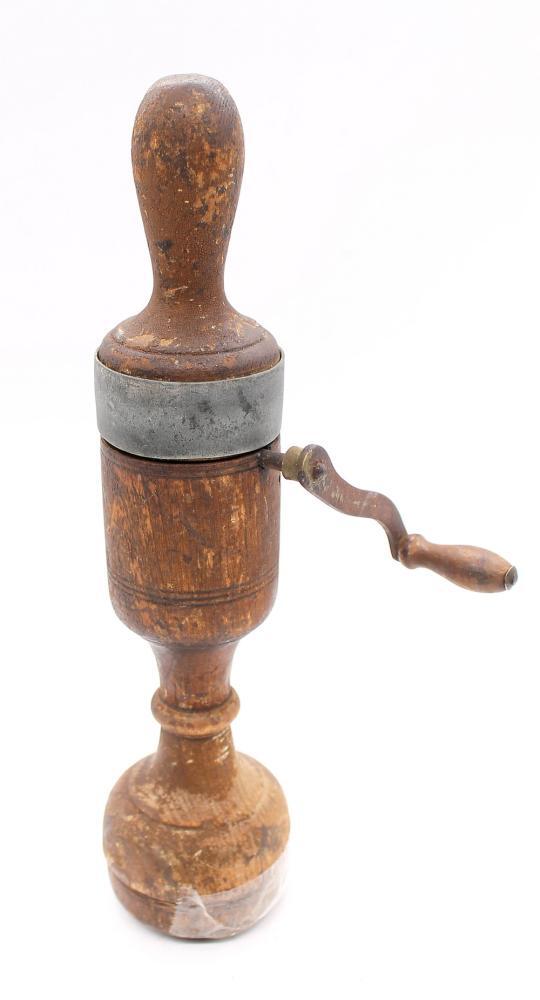A late Victorian medical vibrator, made from turned wood with a metal handle, item rotates when A late Victorian medical vibrator, made from turned wood with a metal handle, item rotates when
