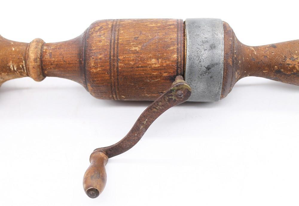A late Victorian medical vibrator, made from turned wood with a metal  handle, item rotates when