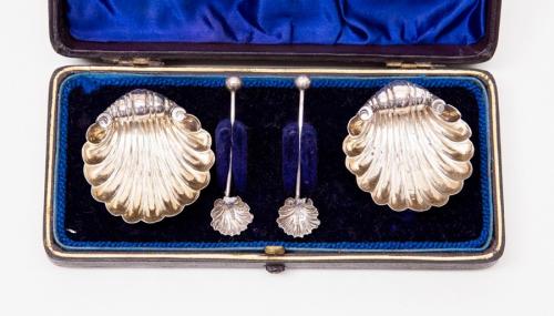 A cased pair of silver shell salts, Birmingham 1894, matching spoons (both repaired) William Henry Leather