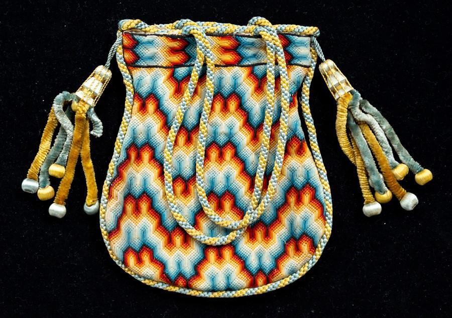 An early 19th Century reticule, circa 1820, hand stitched in wool, in a ...