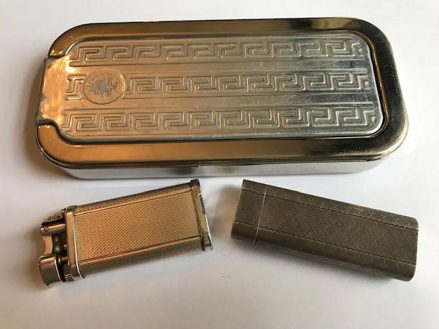 A vintage Cartier white metal pocket lighter, machine engraved, a