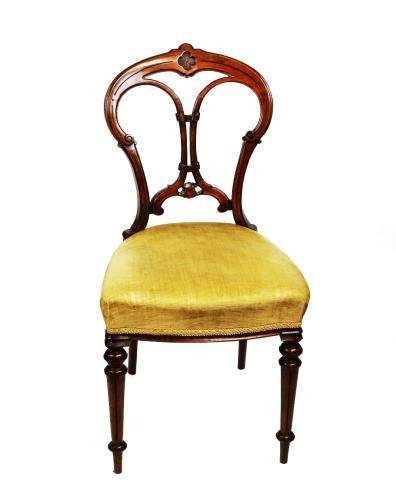 A Victorian mahogany salon chair, shaped central splat above upholstered seat and turned supports