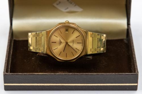 Longines- a gents gilt metal Longines wristwatch, round gold tone dial,  baton markers with date aperture, quartz movement, integral bracelet link  strap, in box