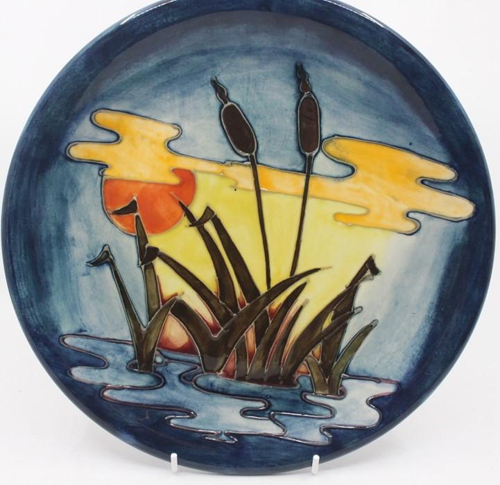 A Moorcroft plate, Reeds at Sunset, by Sally Tuffin, approx 26cm diam ...