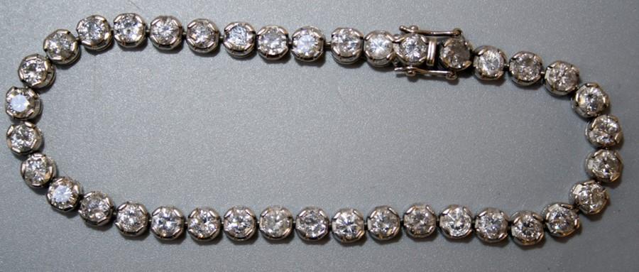 A diamond set line or tennis bracelet, the thirty eight stones mounted ...