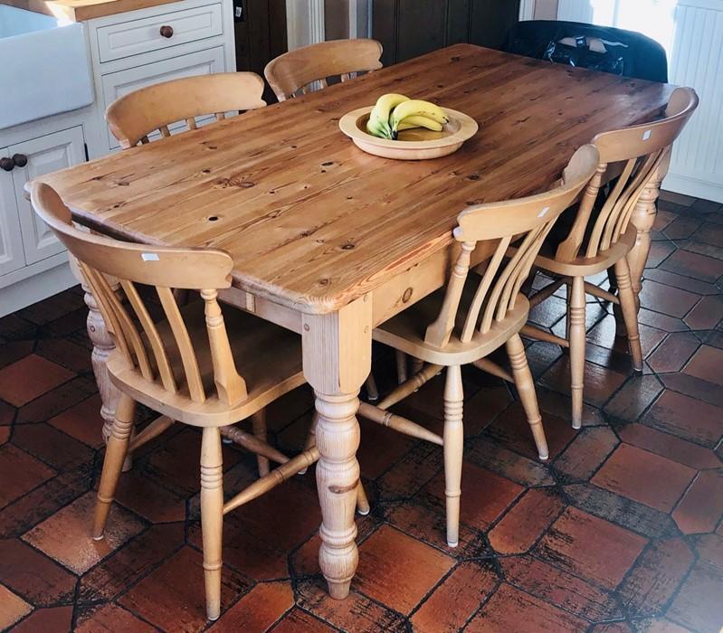 A 20th Century pine kitchen table and six chairs on turned supports (7) table: 77cm H x 168cm W ...